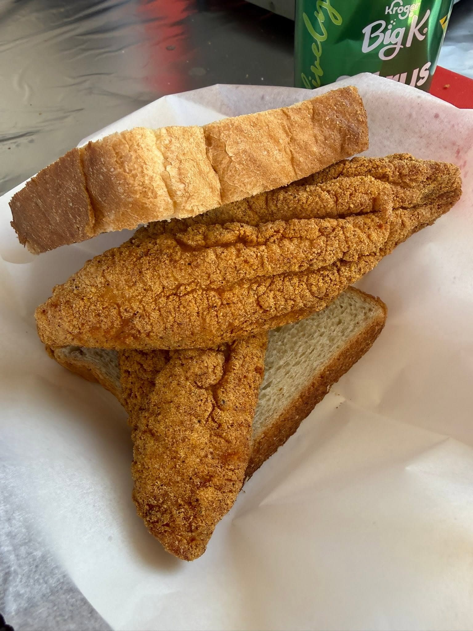 Stacked fried catfish fillets with cornbread slices