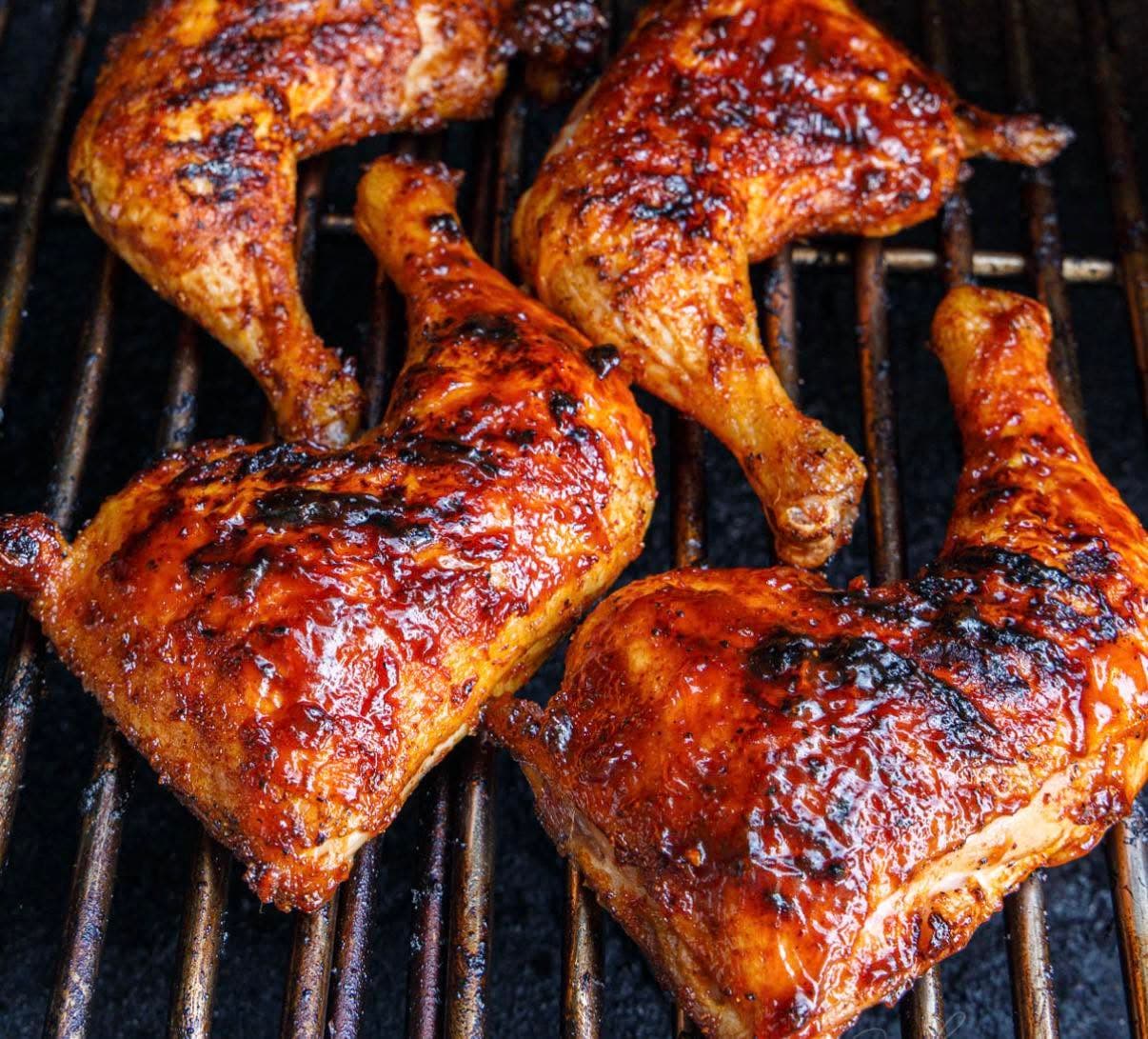Charred Cajun chicken on a smoking grill